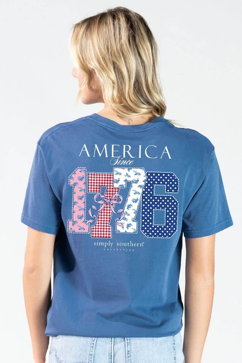 Mineral wash overcast blue tee features the phrase 'America